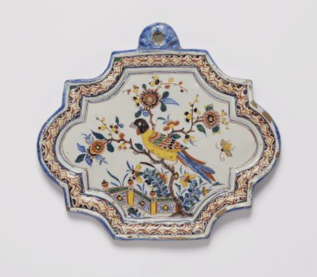 A small Dutch Delft faience plaque with an exotic bird