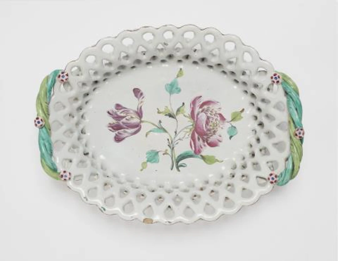 An oval Sceaux faience basket with tulip and peony motifs