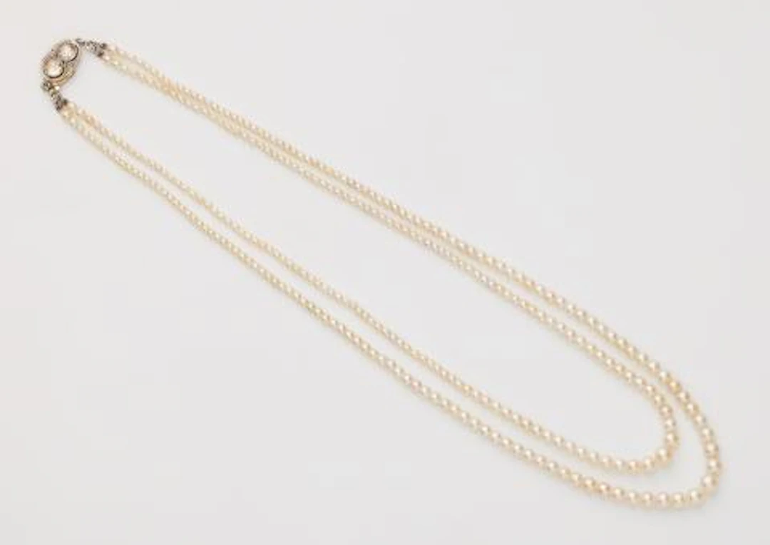 A Belle Epoque two row Oriental pearl necklace with a platinum 14k