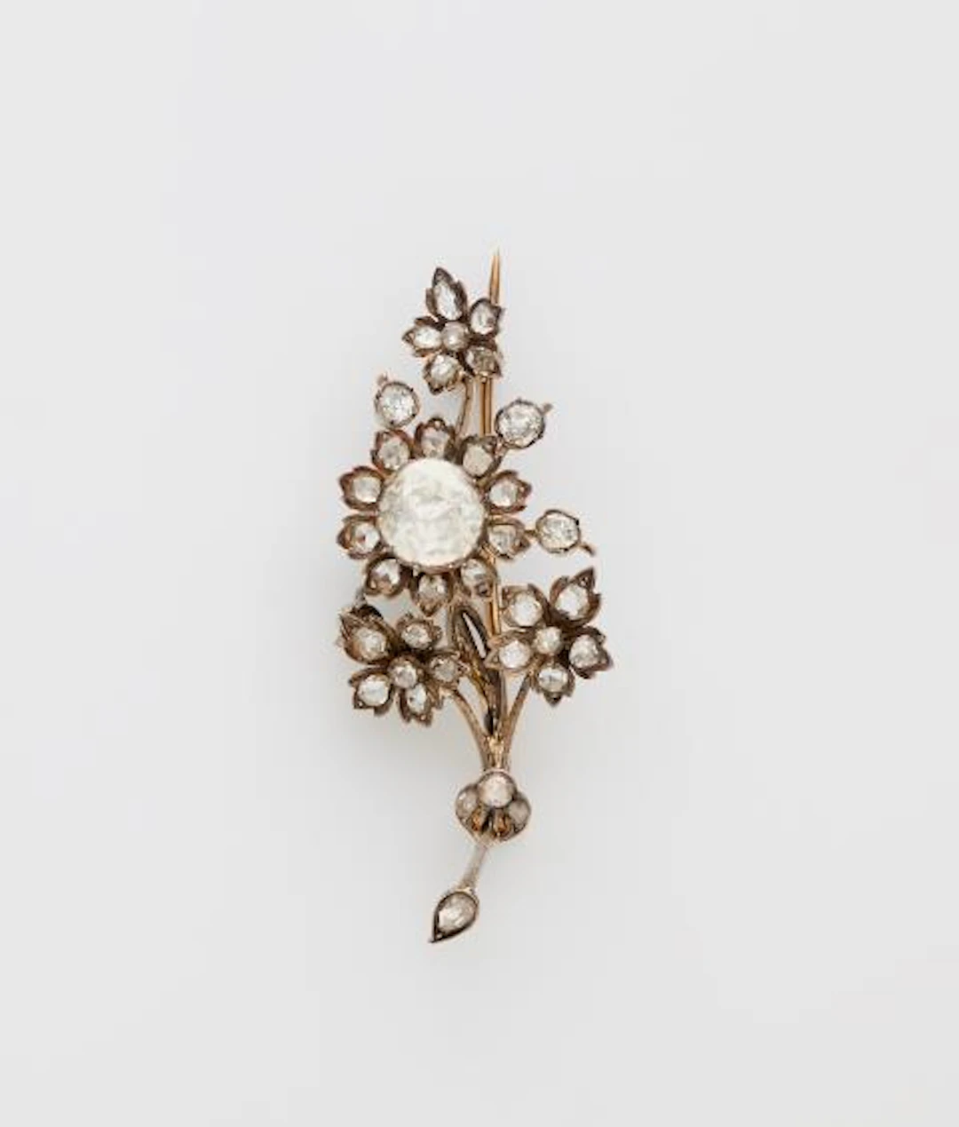 A 14k gold silver and diamond naturalistic flowering branch tremblant brooch.