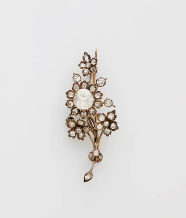 A 14k gold silver and diamond naturalistic flowering branch tremblant brooch.