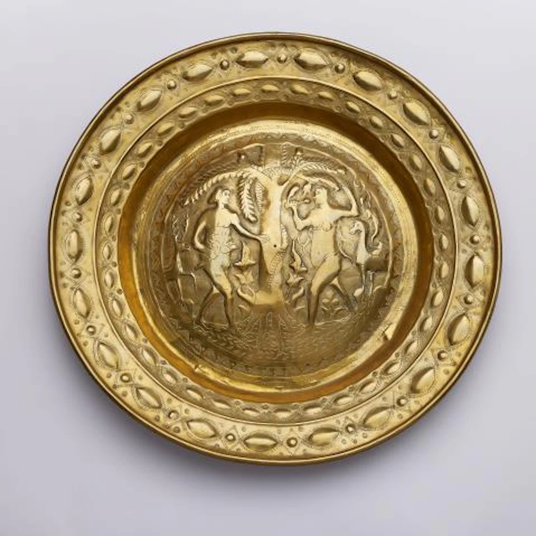 A brass alms bowl with Adam and Eve