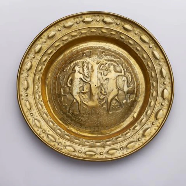 A brass alms bowl with Adam and Eve