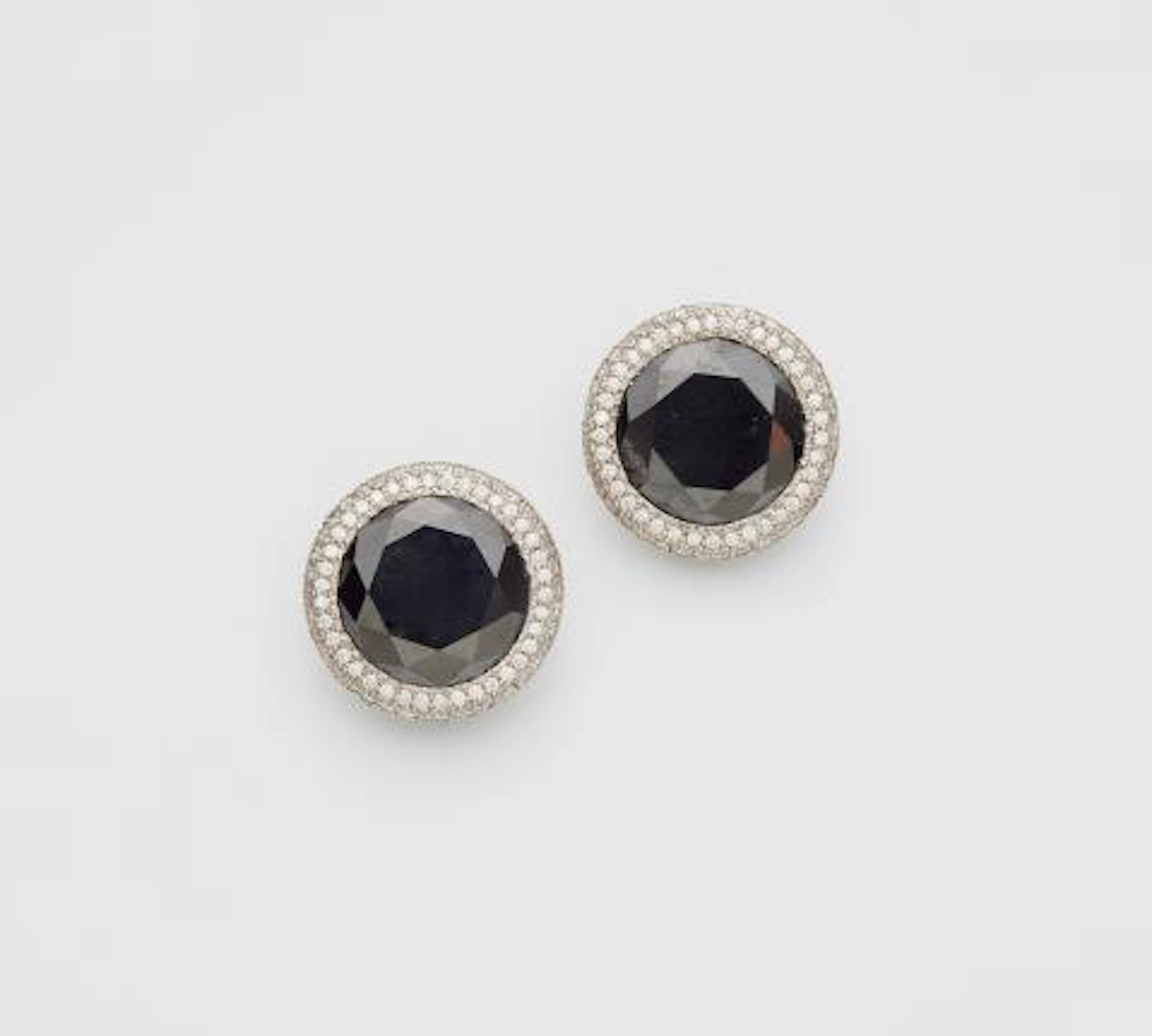A pair of 18k white gold black & white diamond clip earrings.