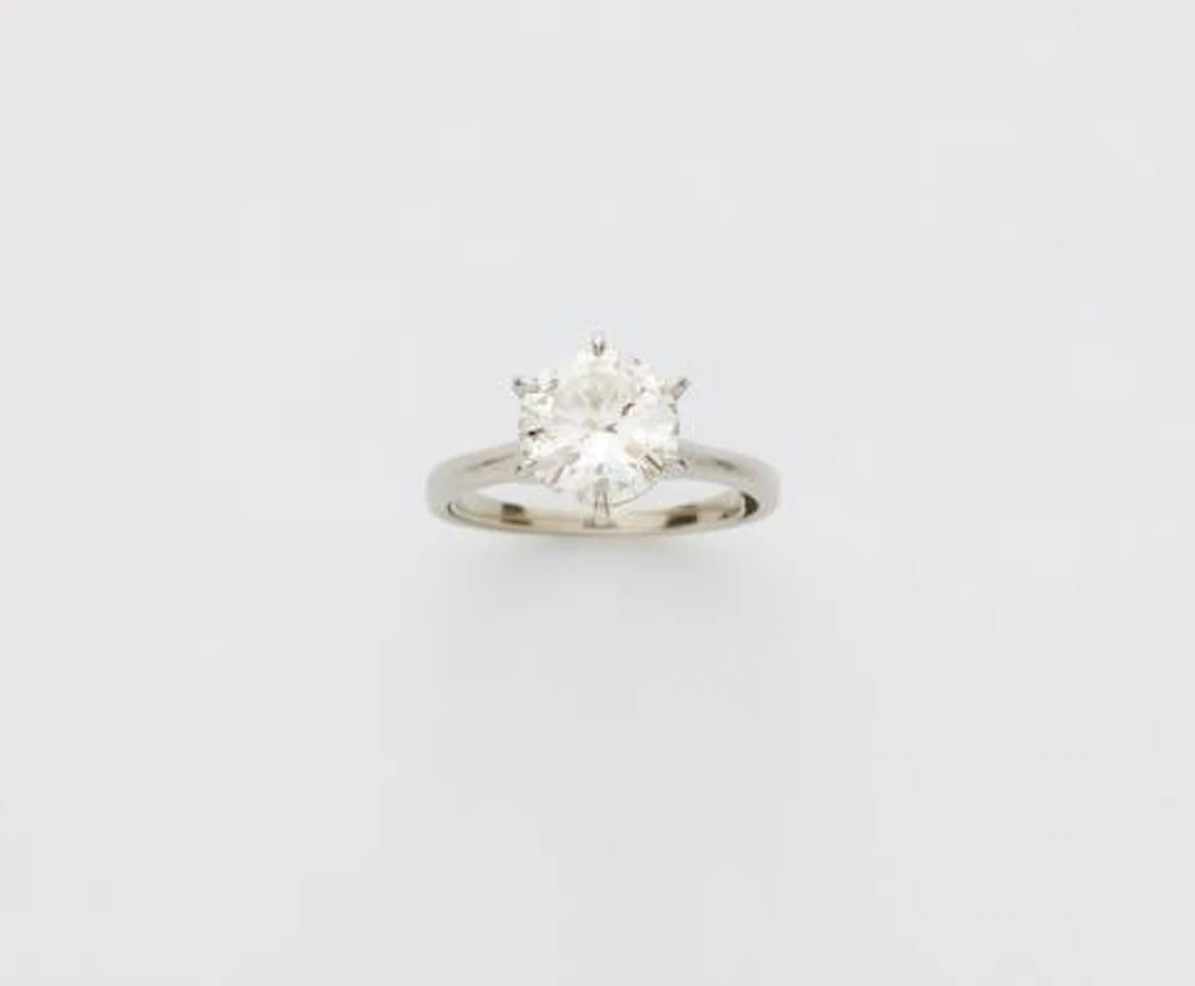 A platinum and brilliant-cut diamond solitaire ring.