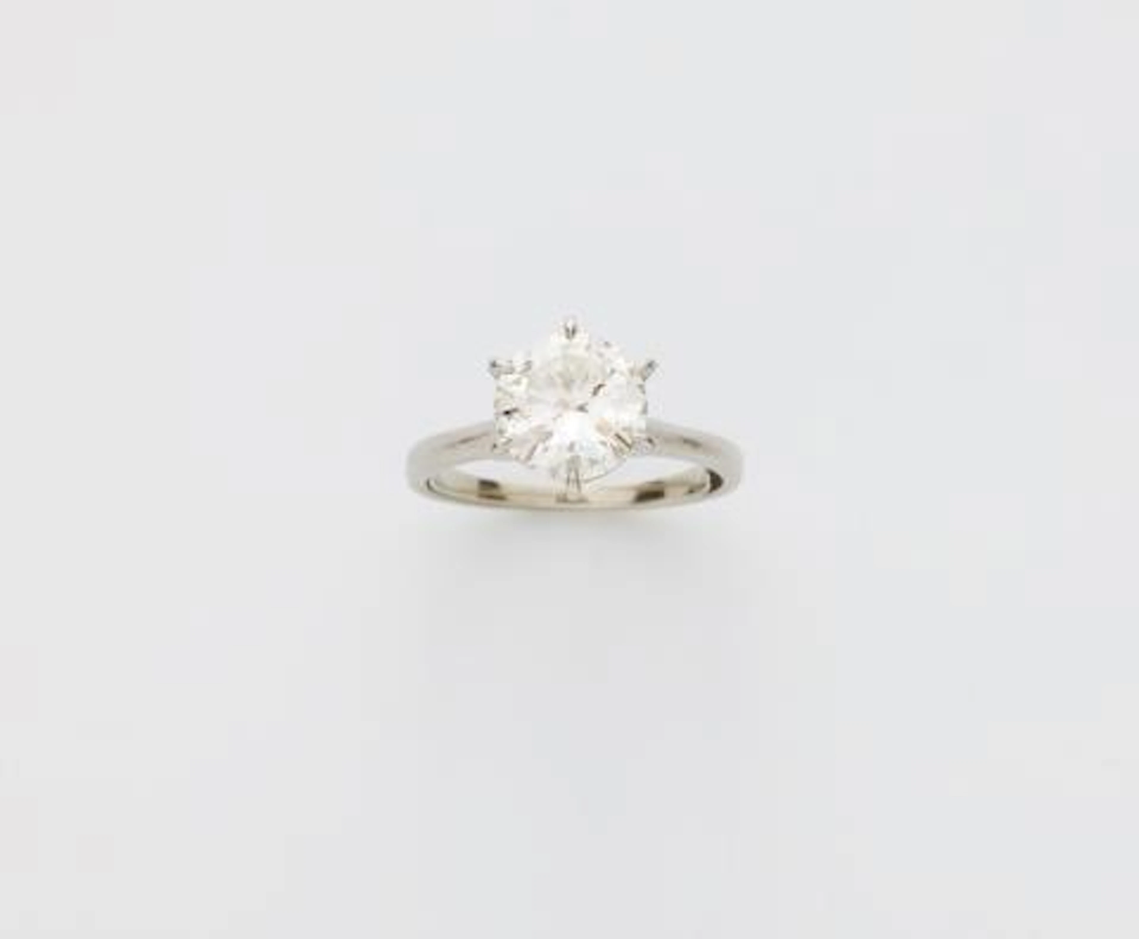 A platinum and brilliant-cut diamond solitaire ring.