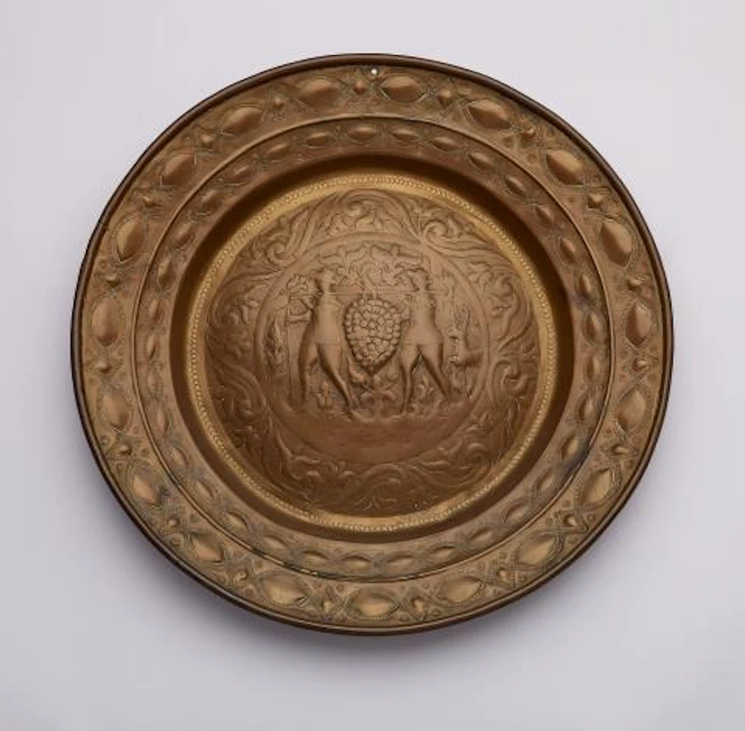 A brass alms bowl with Joshua and Caleb