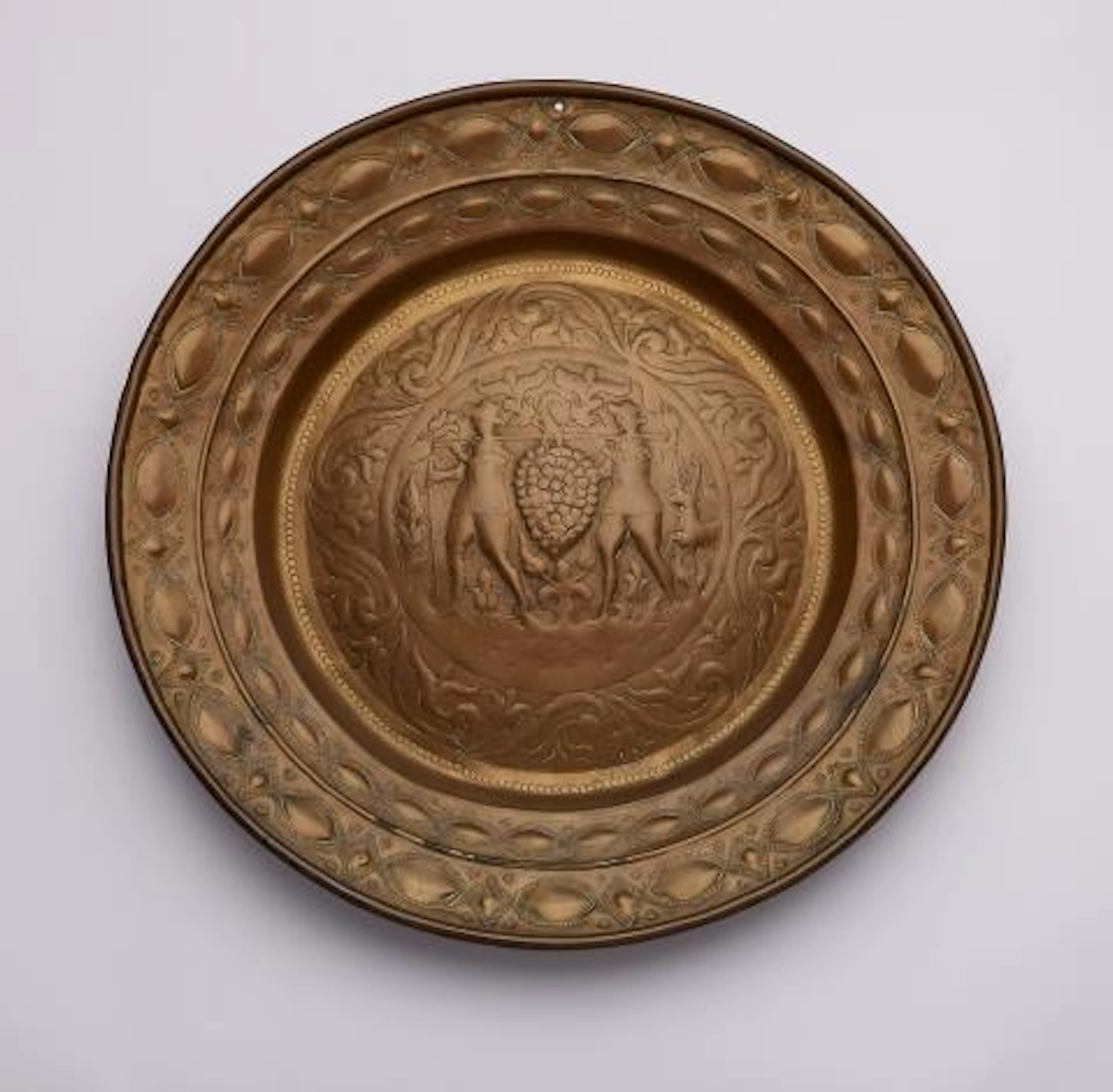 A brass alms bowl with Joshua and Caleb
