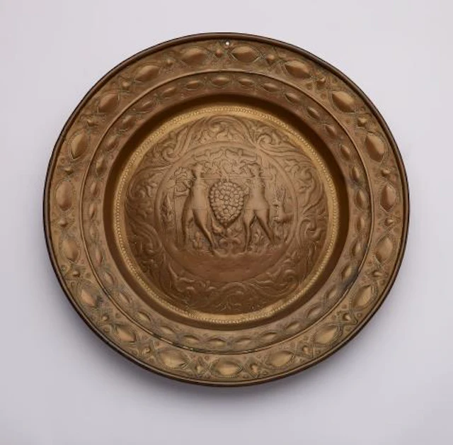 A brass alms bowl with Joshua and Caleb