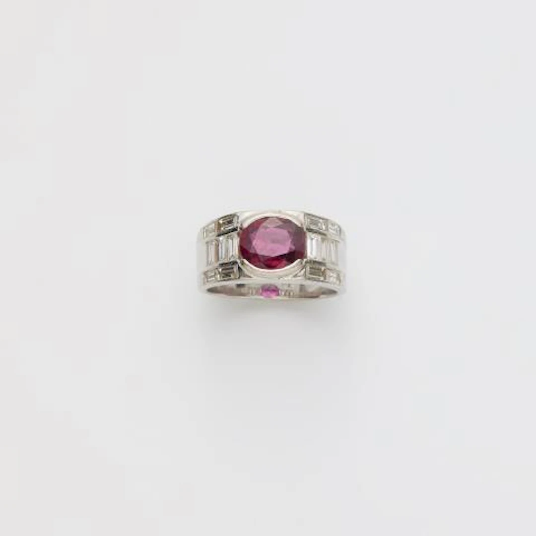 A rhodinated 18k yellow gold diamond and Thai ruby band ring.