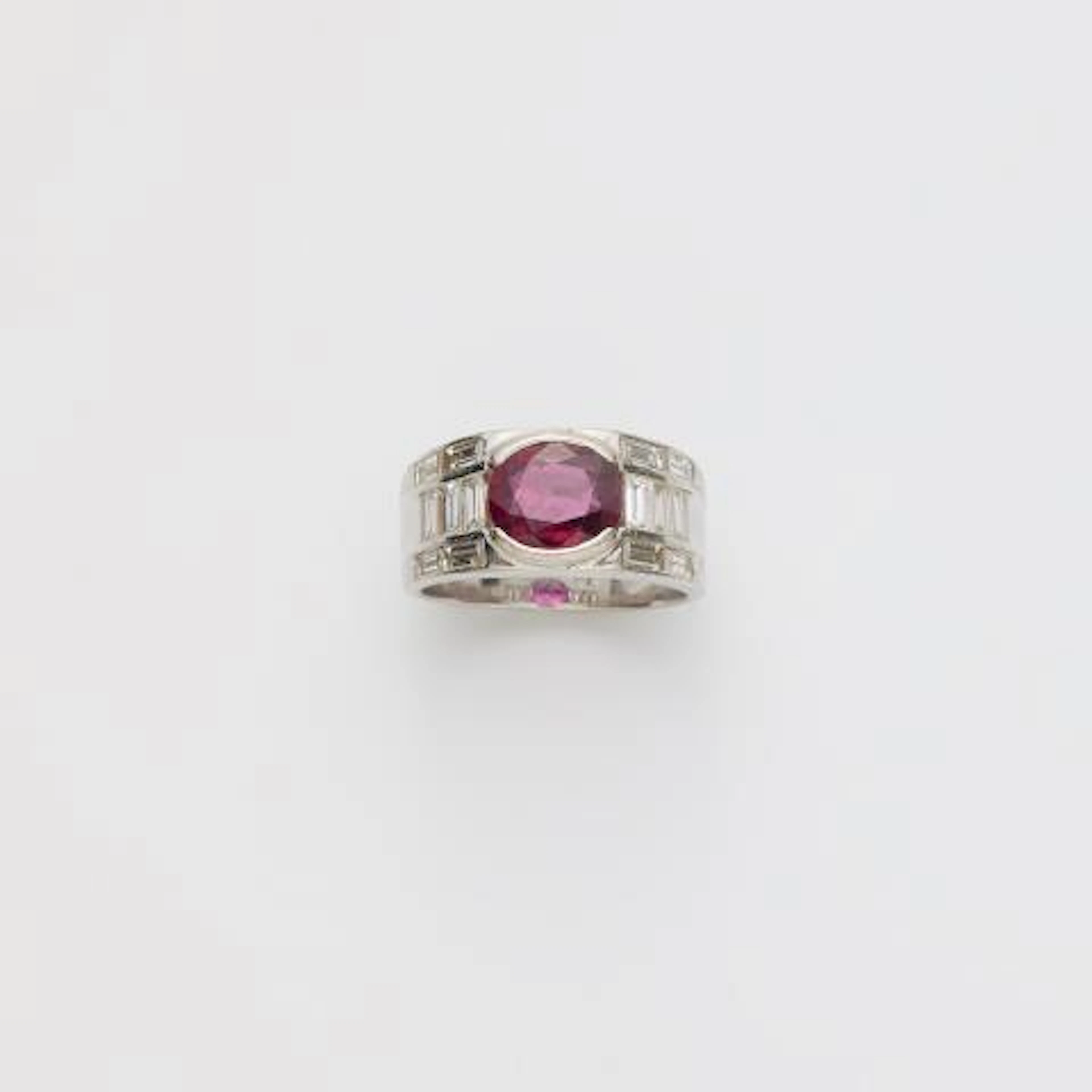 A rhodinated 18k yellow gold diamond and Thai ruby band ring.