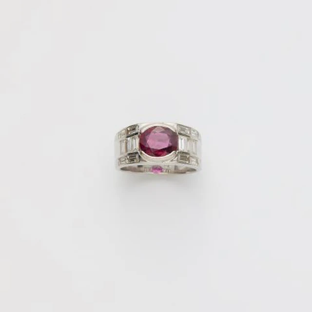 A rhodinated 18k yellow gold diamond and Thai ruby band ring.