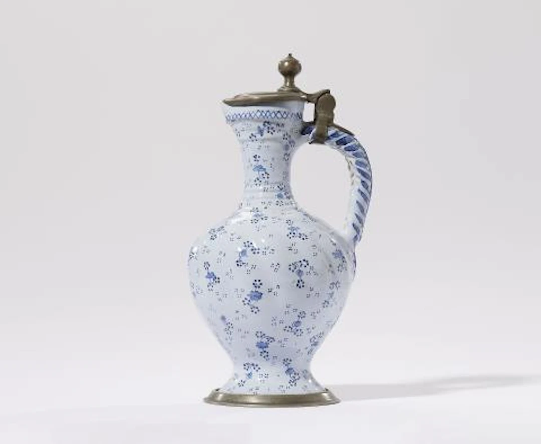 A German faience jug with flower and dot motifs
