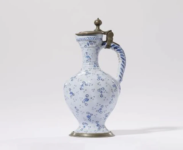 A German faience jug with flower and dot motifs
