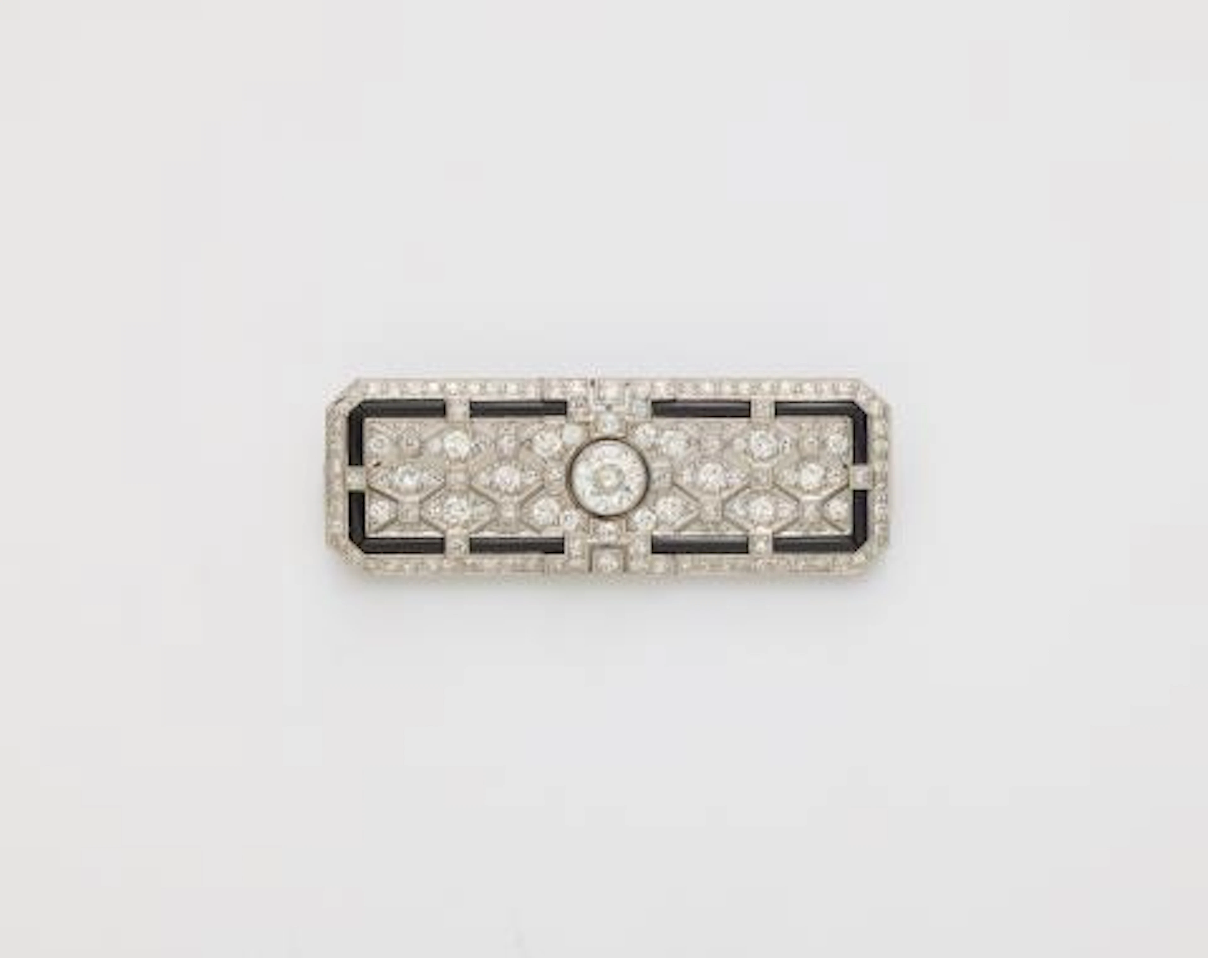 A platinum 18k gold diamond and onyx Art Déco brooch with original