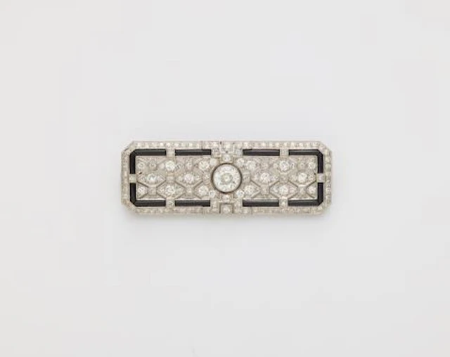 A platinum 18k gold diamond and onyx Art Déco brooch with original