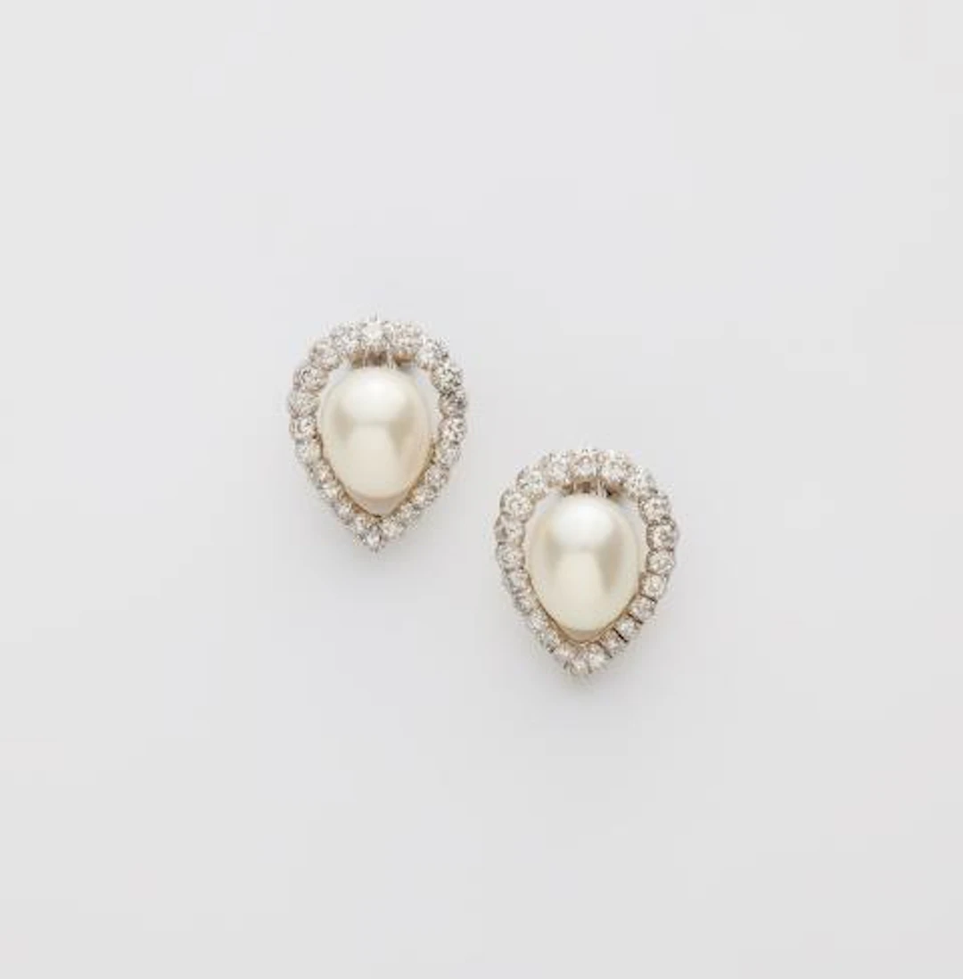 A pair of platinum 18k gold diamond and cultured pearl clip earrings.