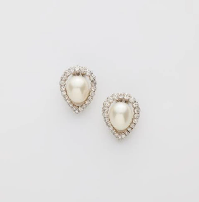 A pair of platinum 18k gold diamond and cultured pearl clip earrings.