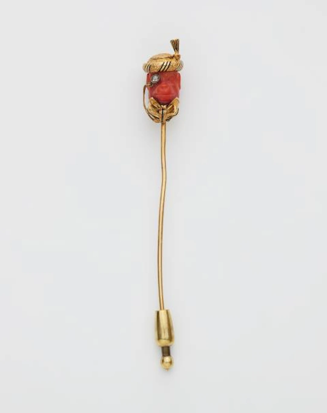 An 18k gold black enamel diamond and carved Mediterranian Sea coral