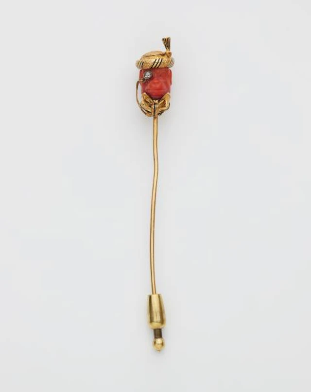An 18k gold black enamel diamond and carved Mediterranian Sea coral