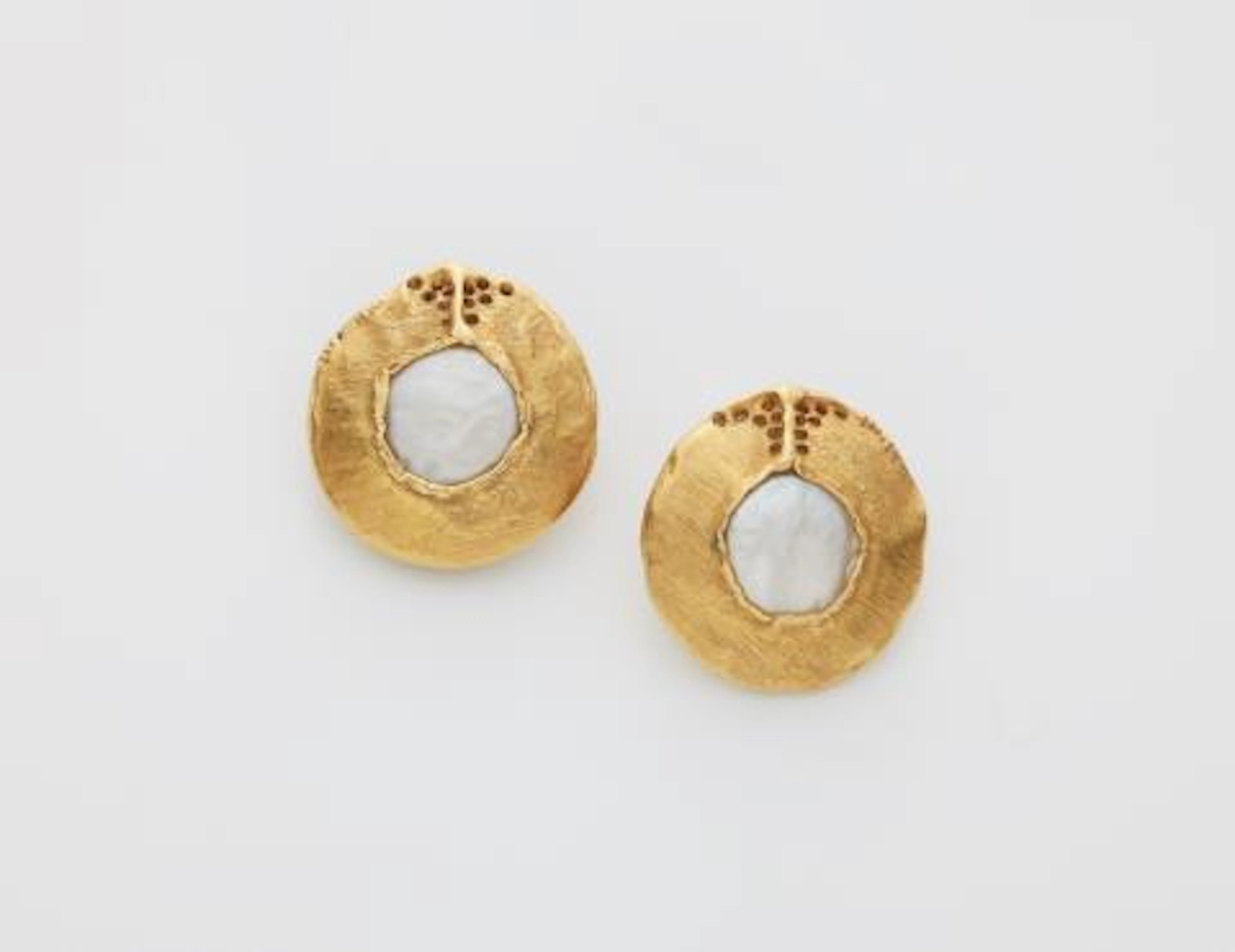 A pair of German 18k gold and mother of pearl disc clip earrings.