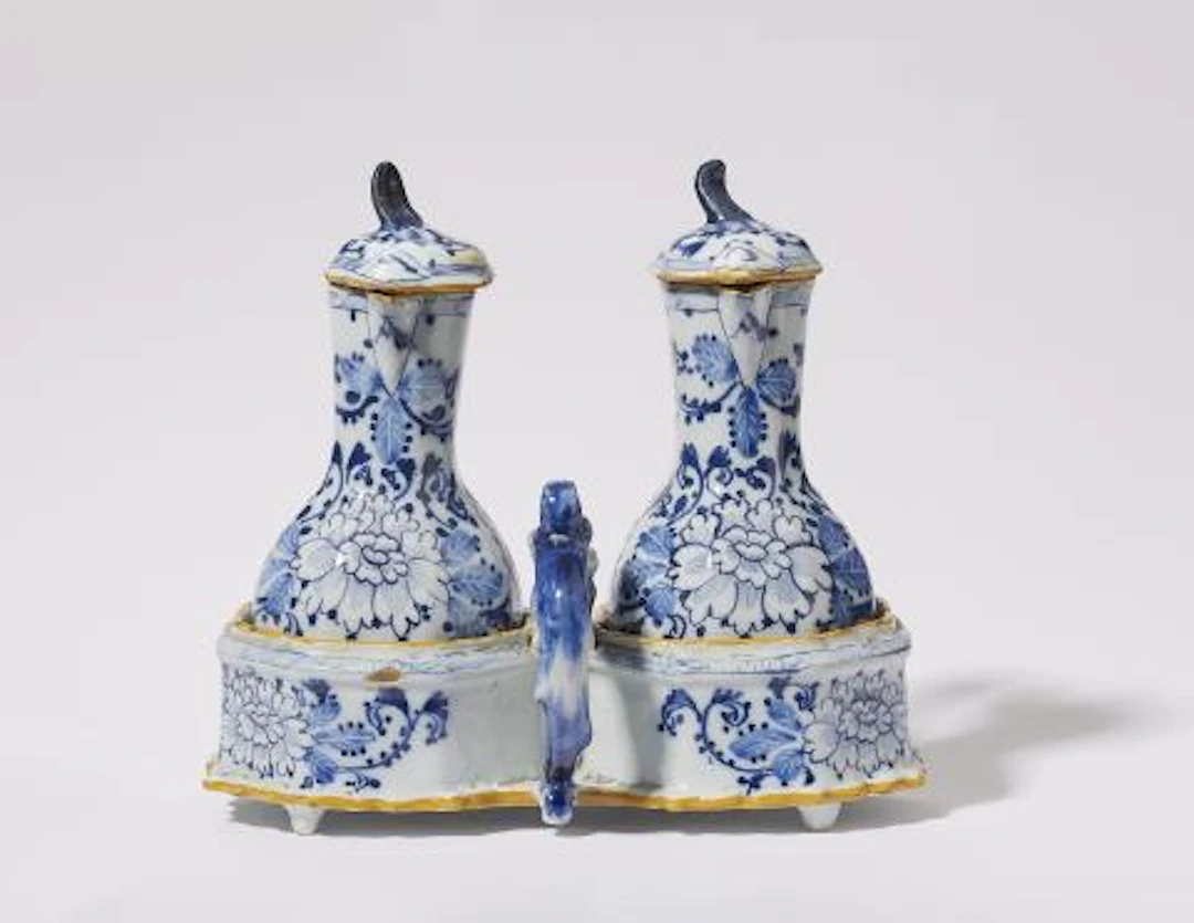 A Dutch Delft faience oil and vinegar cruet set