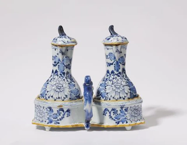 A Dutch Delft faience oil and vinegar cruet set