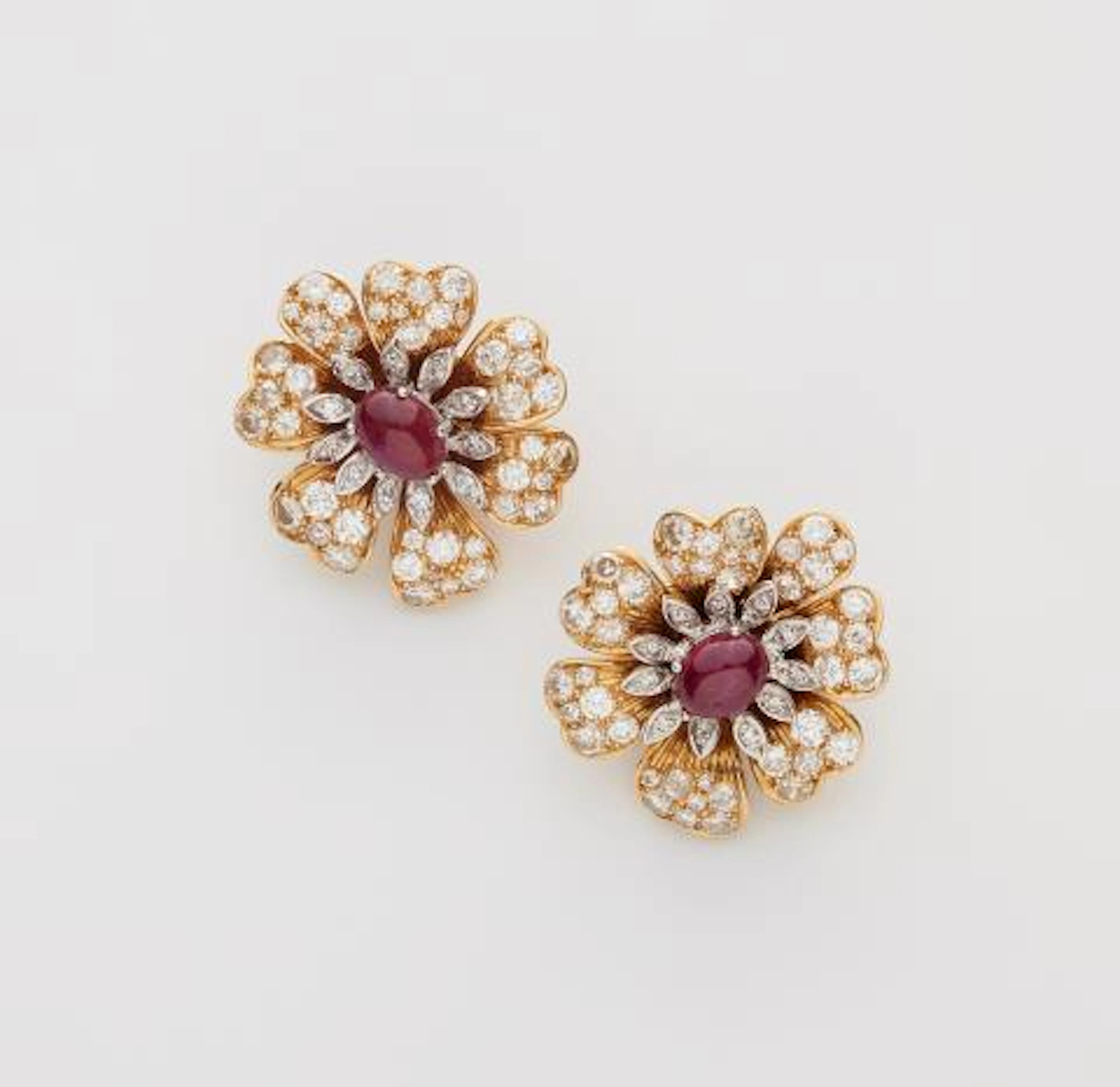 A pair of 18k yellow gold diamond and ruby clip earrings.