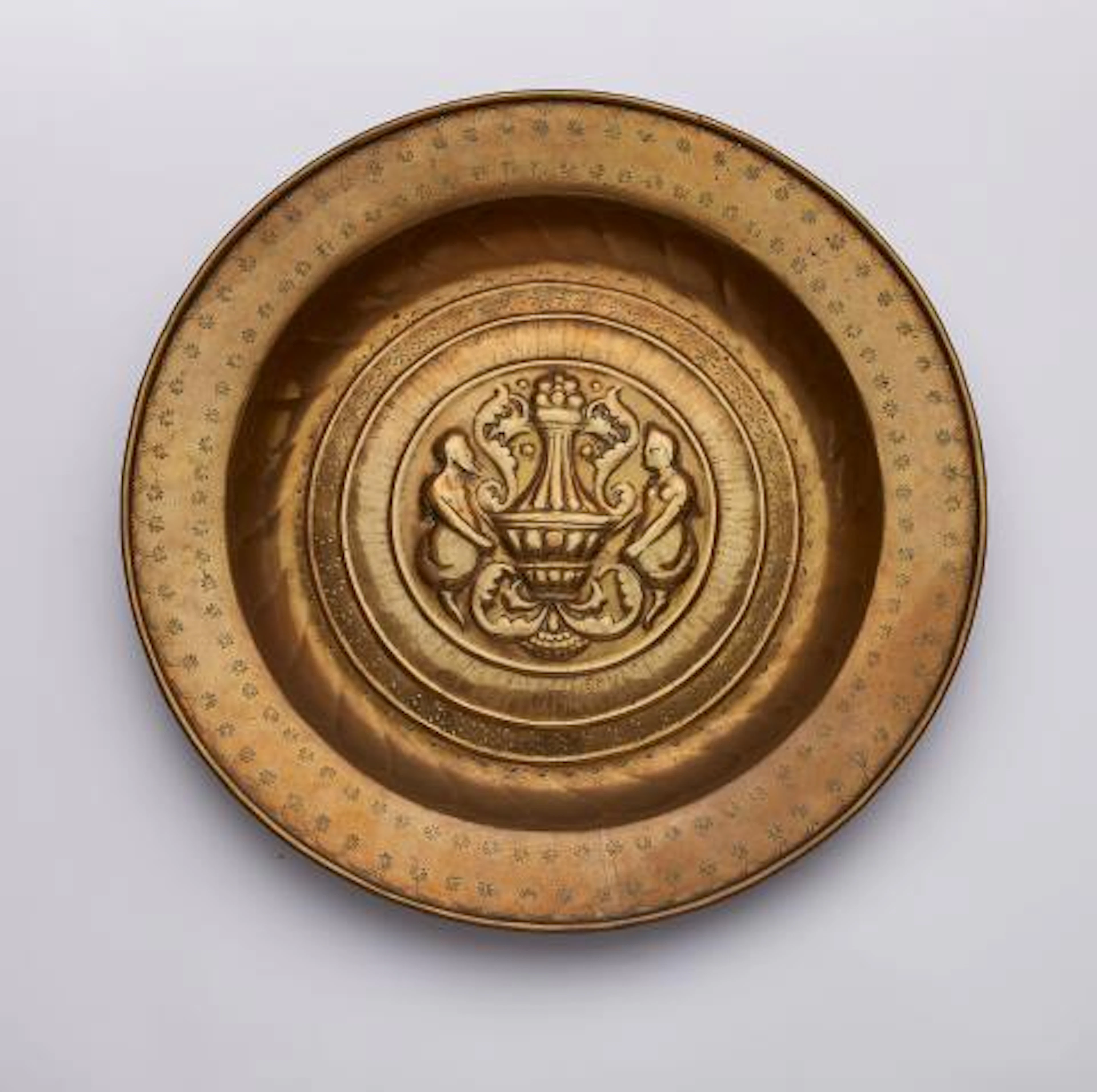 A brass 'Beckenschlägerschüssel' with two satyrs
