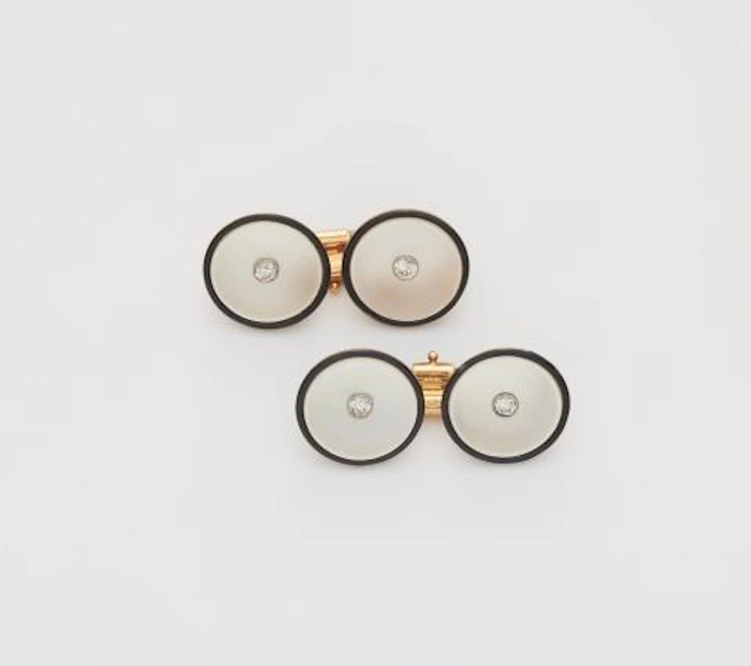 A pair of mother of pearl, black enamel and diamond Art Déco cufflinks