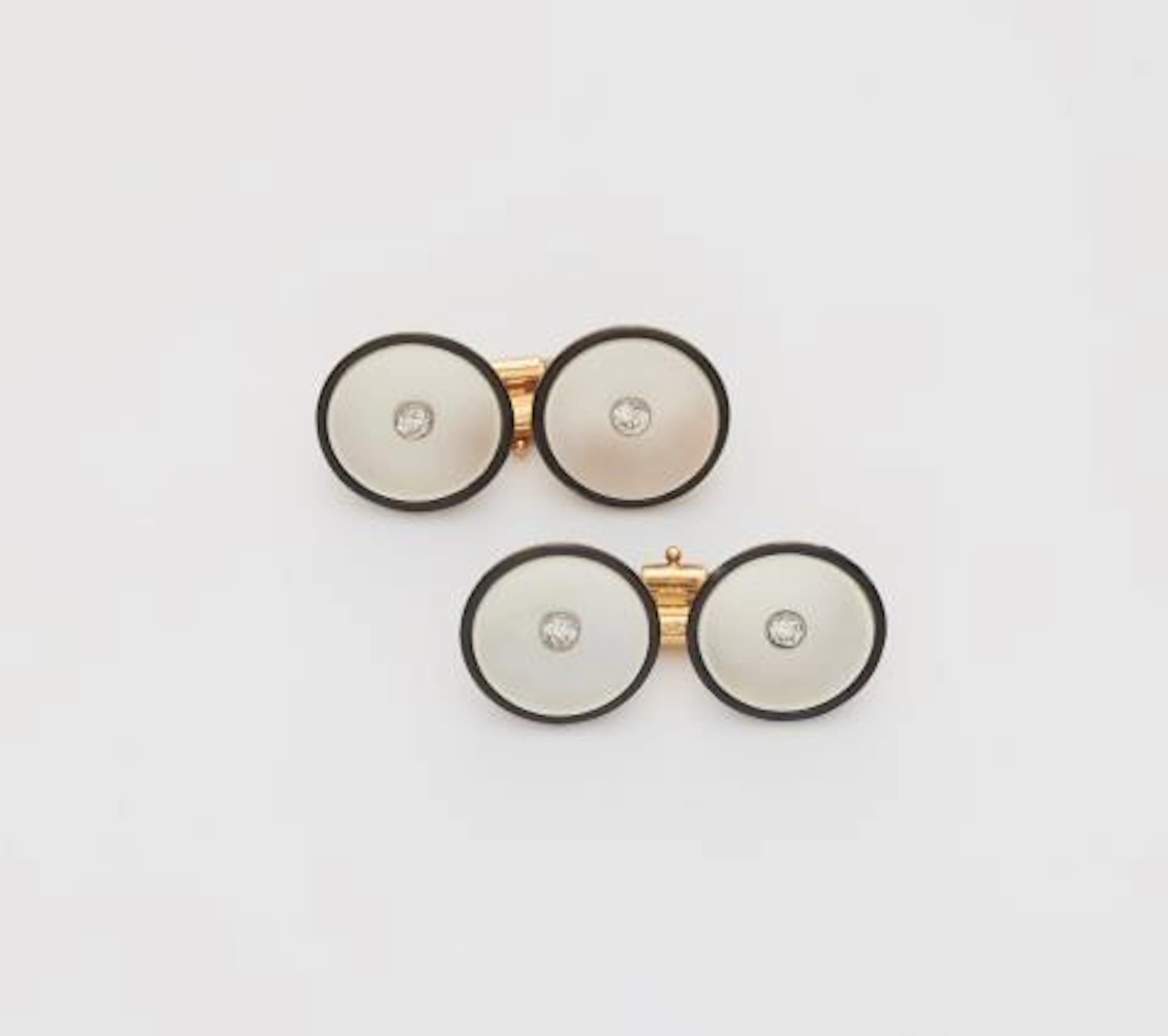 A pair of mother of pearl, black enamel and diamond Art Déco cufflinks