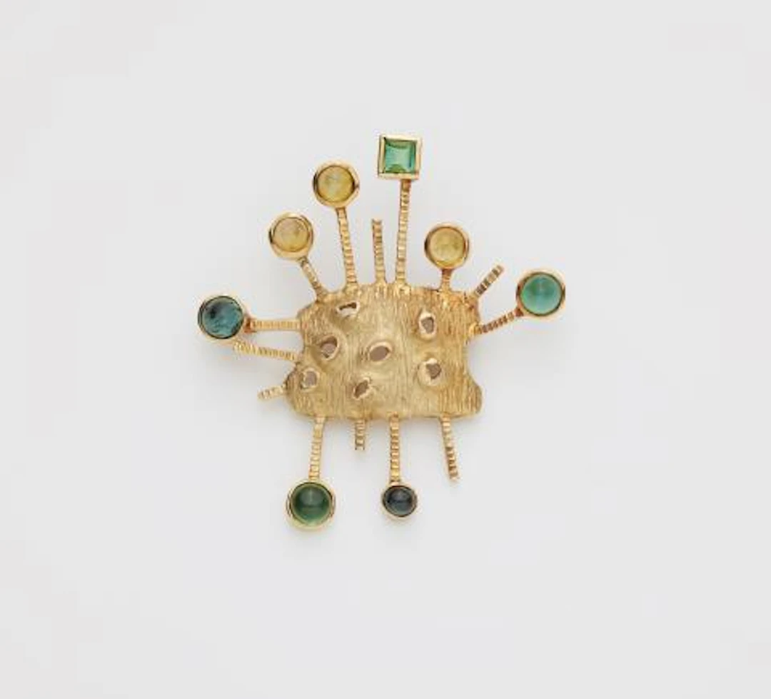 An abstract textured 14k gold tourmaline and citrine brooch.