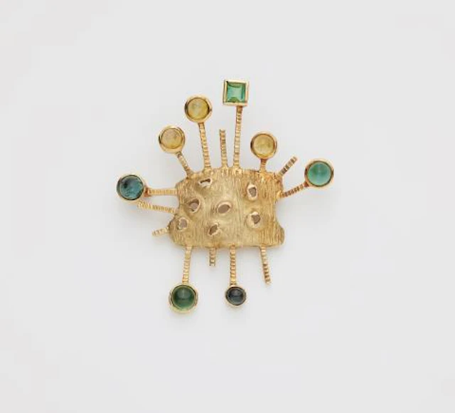 An abstract textured 14k gold tourmaline and citrine brooch.