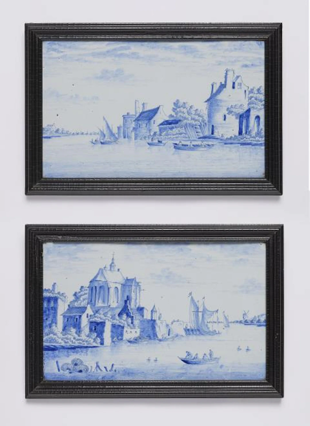 A pair of Dutch Delft faience plaques depicting two views of a Dutch