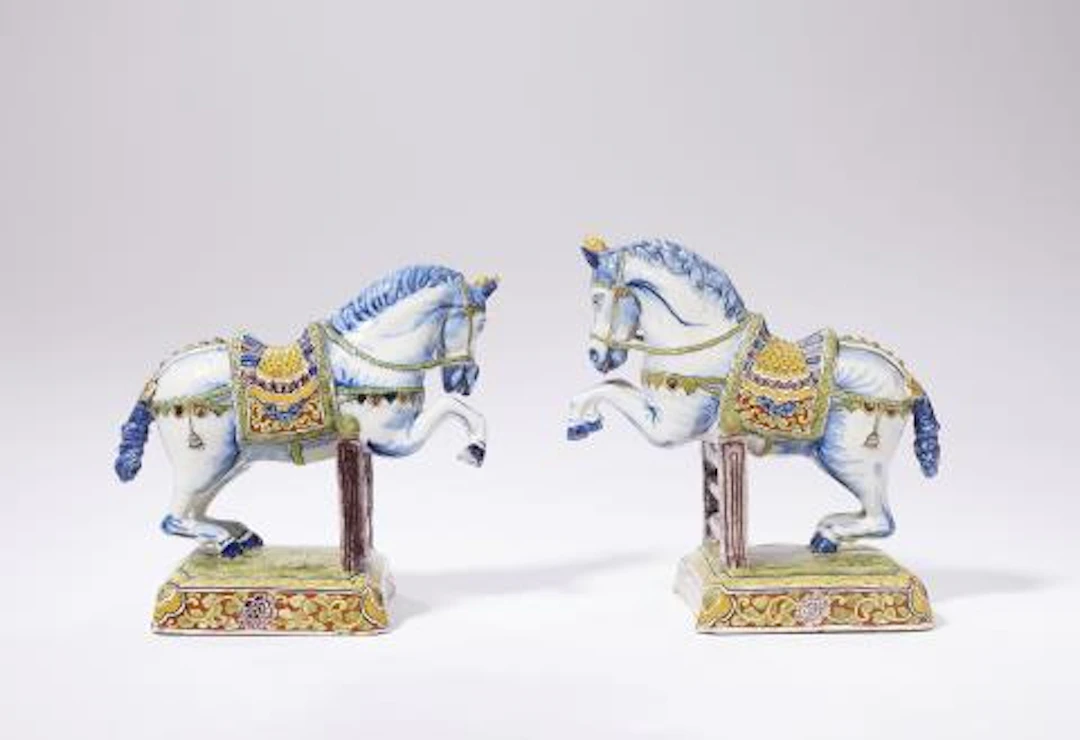 A pair of exceptional dated Dutch Delft faience figures of leaping horses