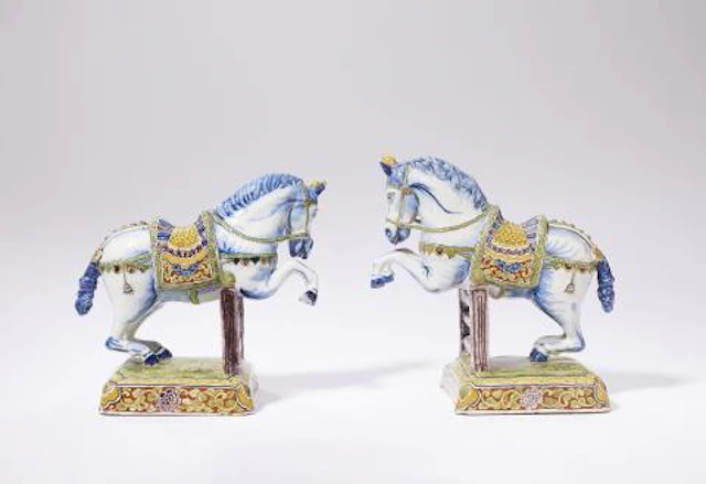 A pair of exceptional dated Dutch Delft faience figures of leaping horses
