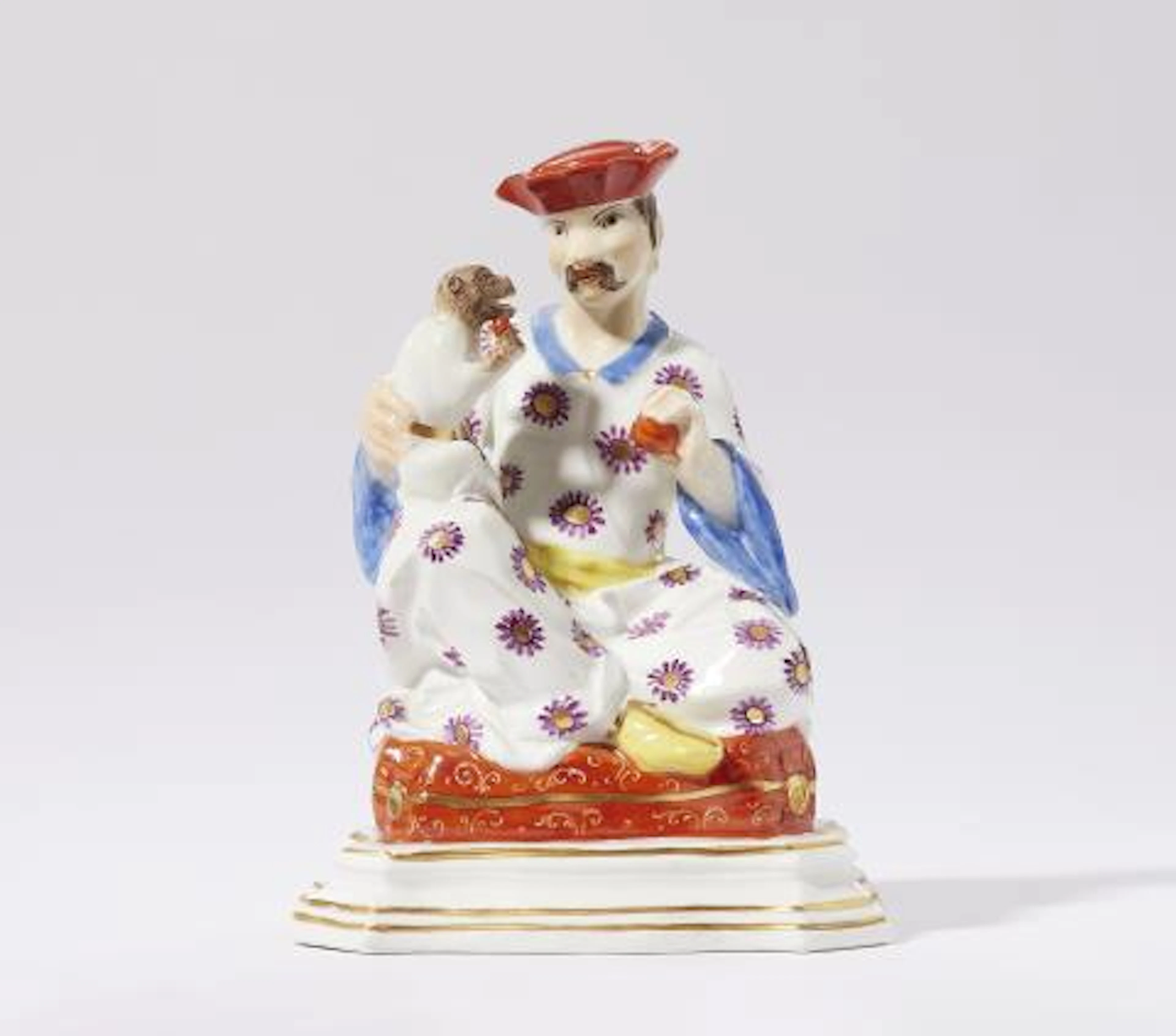 A Meissen porcelain model of a seated male pagode with a monkey