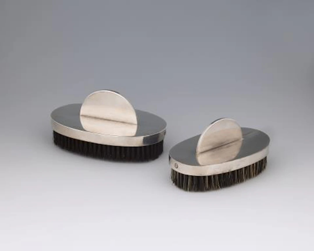 Two clothes brushes by Emmy Roth