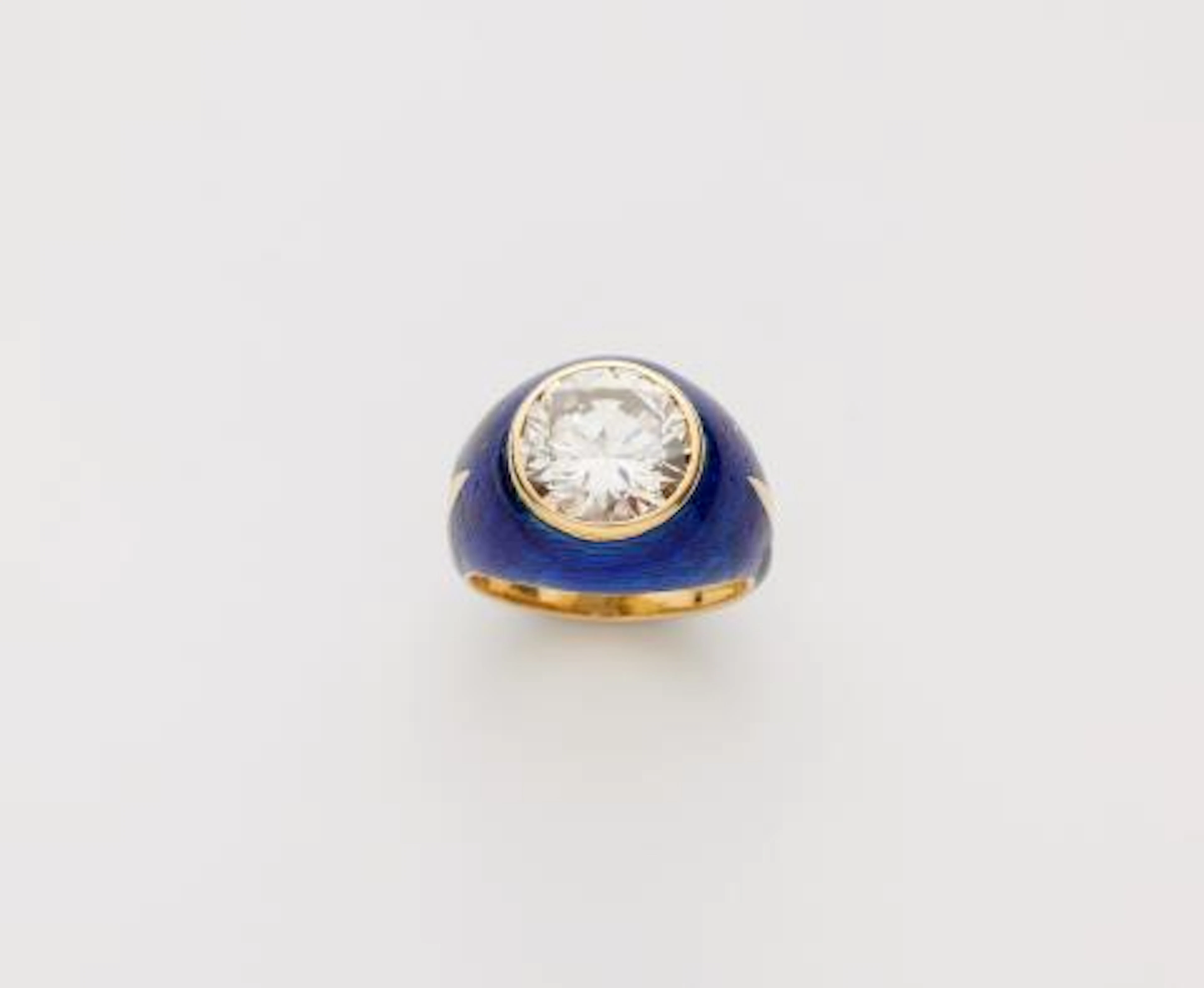 An 18k gold translucent blue enamel and diamond solitaire band ring.