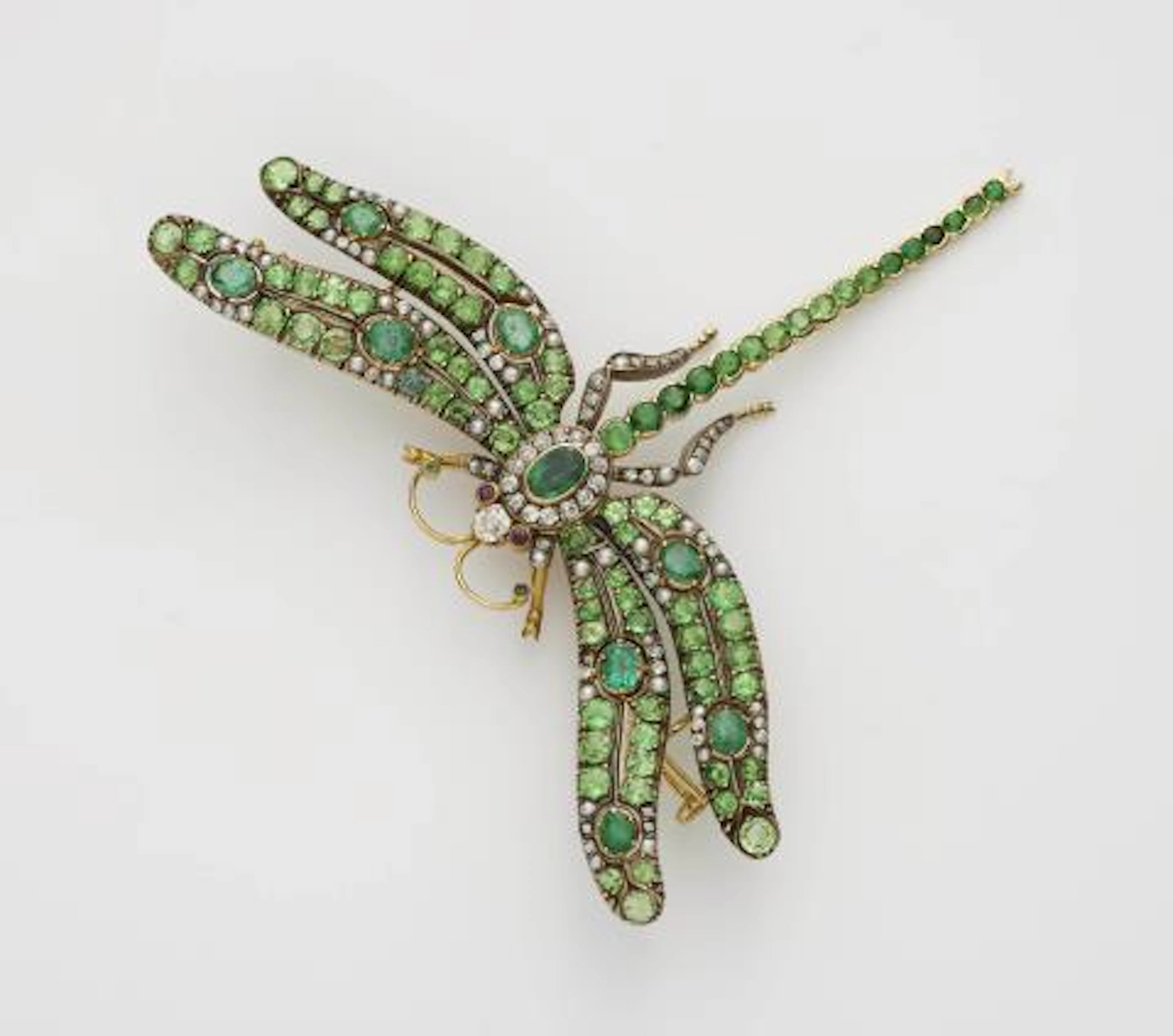 An 18k gold tsavorite, diamond, emerald and seed pearl Art Nouveau