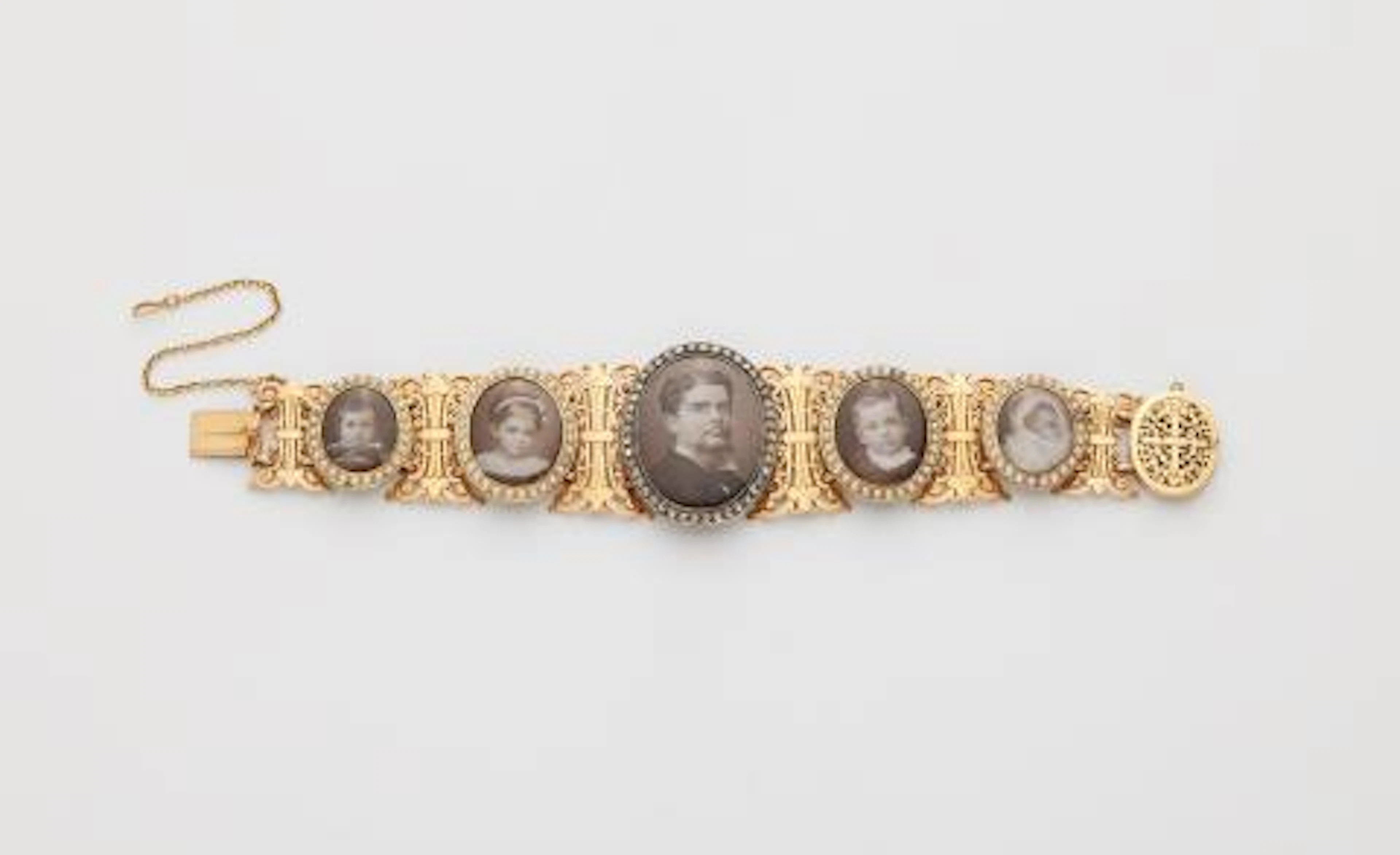A late 19th century 18k gold pearl diamond mother of pearl and photo