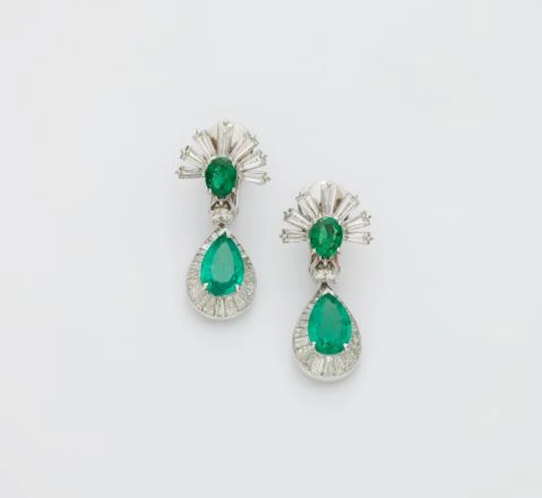 A pair of 14k white gold emerald and diamond pendant earrings with