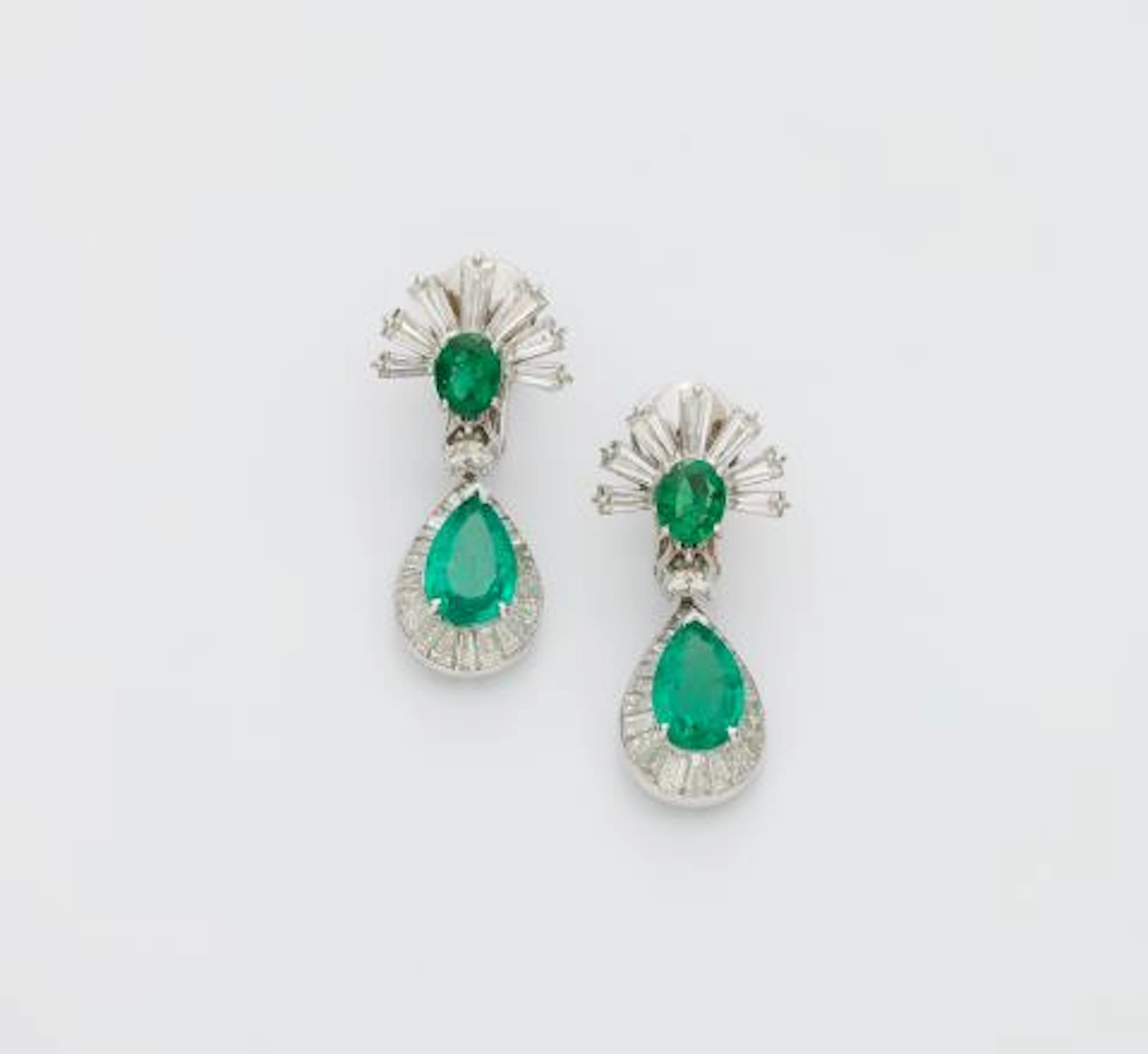 A pair of 14k white gold emerald and diamond pendant earrings with