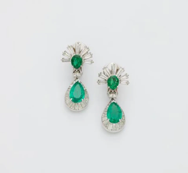 A pair of 14k white gold emerald and diamond pendant earrings with