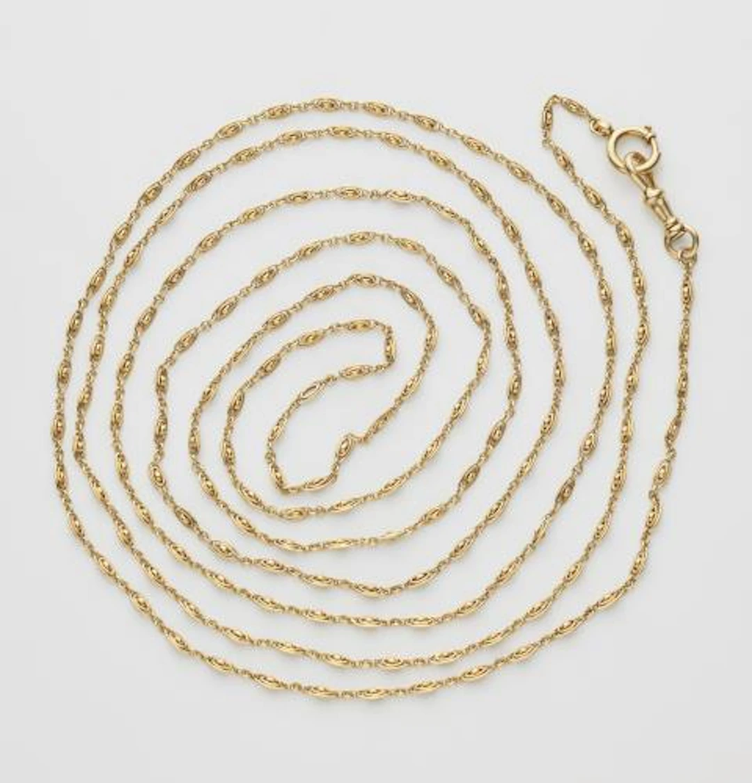A 14k yellow gold Belle Epoque sautoir with carabiner clasp.