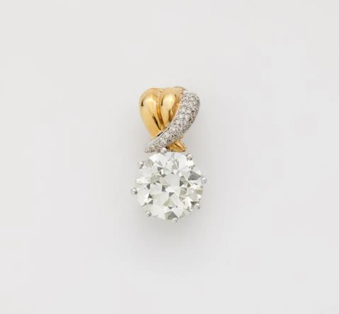 An 18k bicolour gold pendant using a 7.43 ct transition-cut diamond
