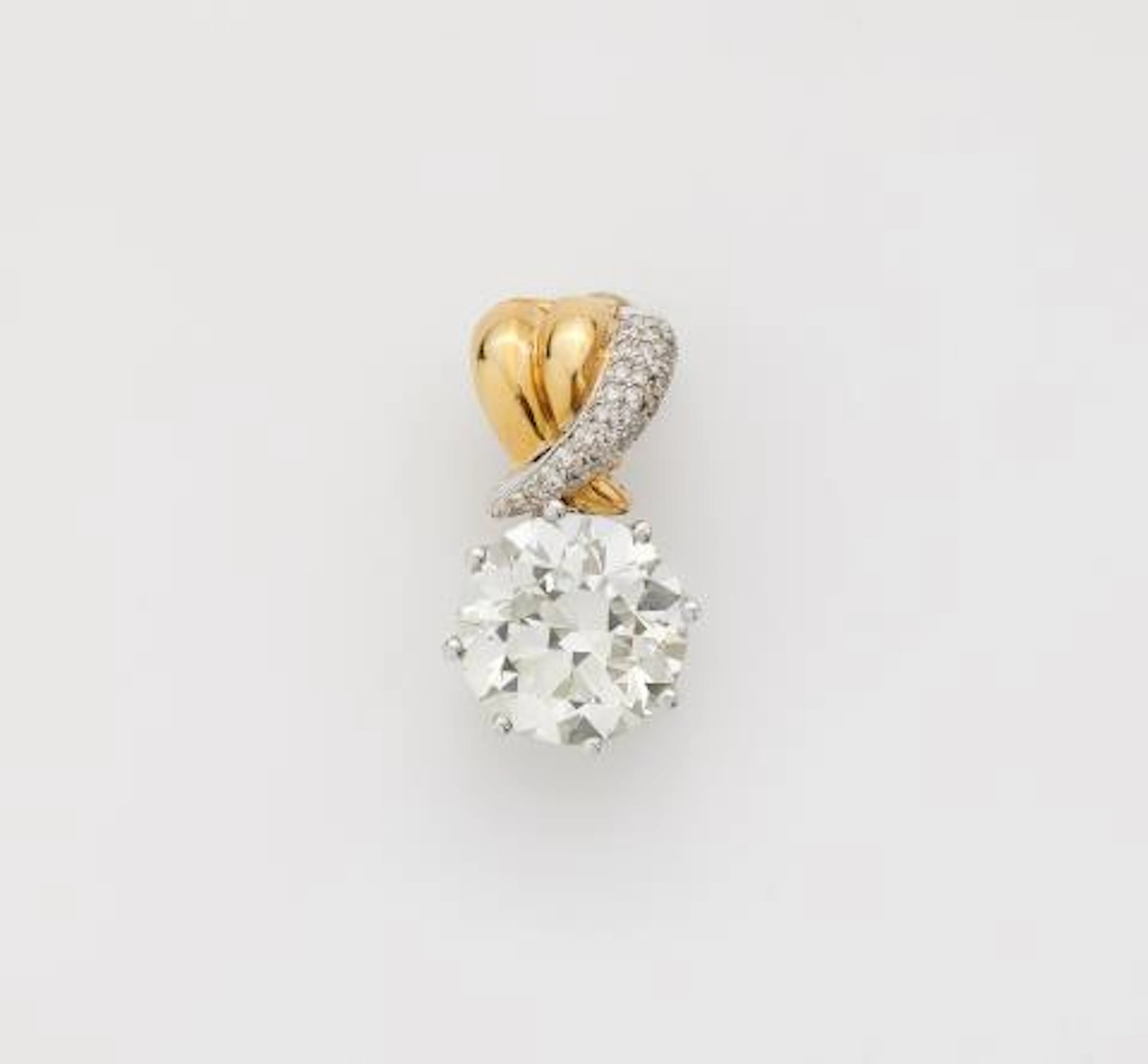 An 18k bicolour gold pendant using a 7.43 ct transition-cut diamond
