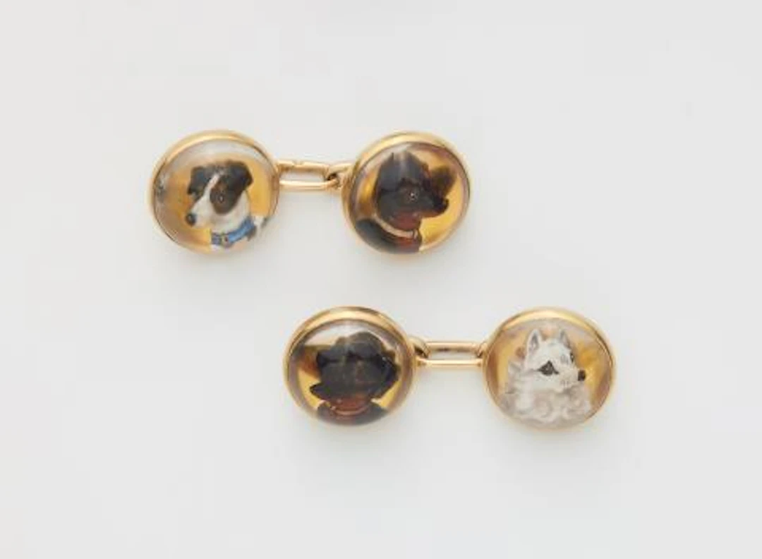 A pair of 14k gold and Essex crystal cufflinks with dog heads.