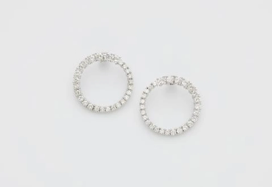 A pair of 18k white gold and diamond loop stud earrings.