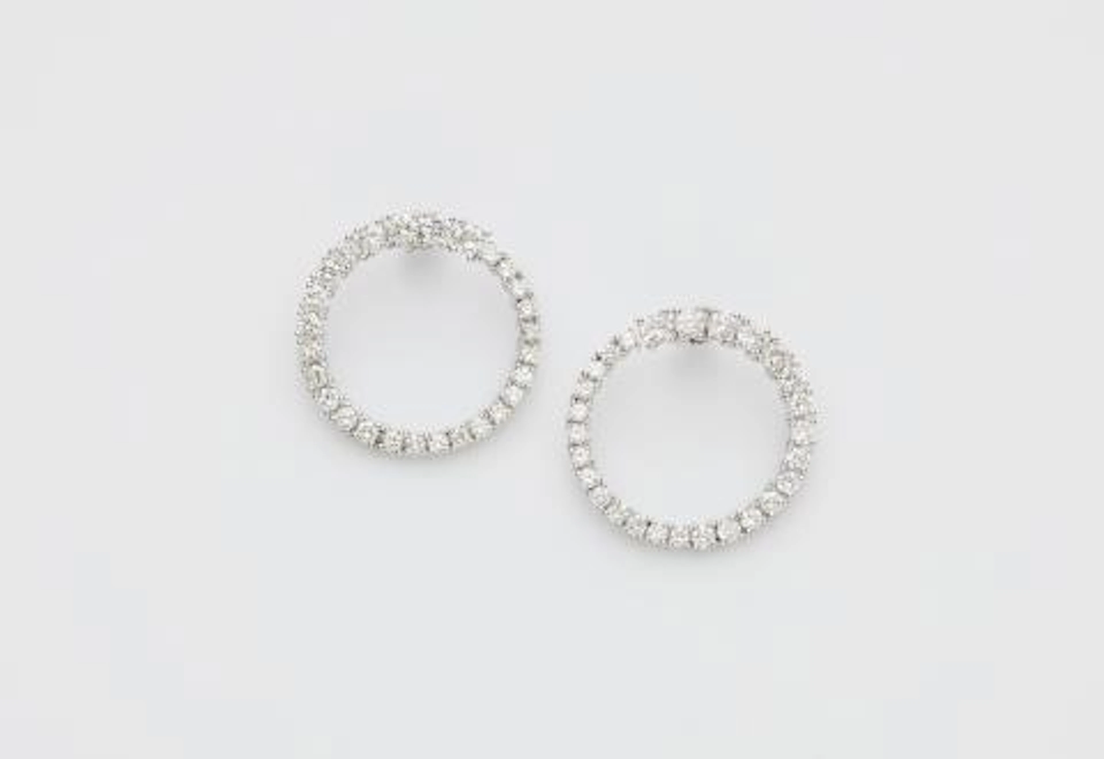 A pair of 18k white gold and diamond loop stud earrings.